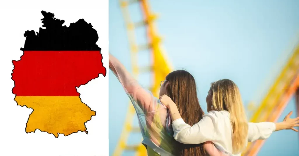 deutschland fahne und zwei teenager maedchen vorm themenpark riesenrad